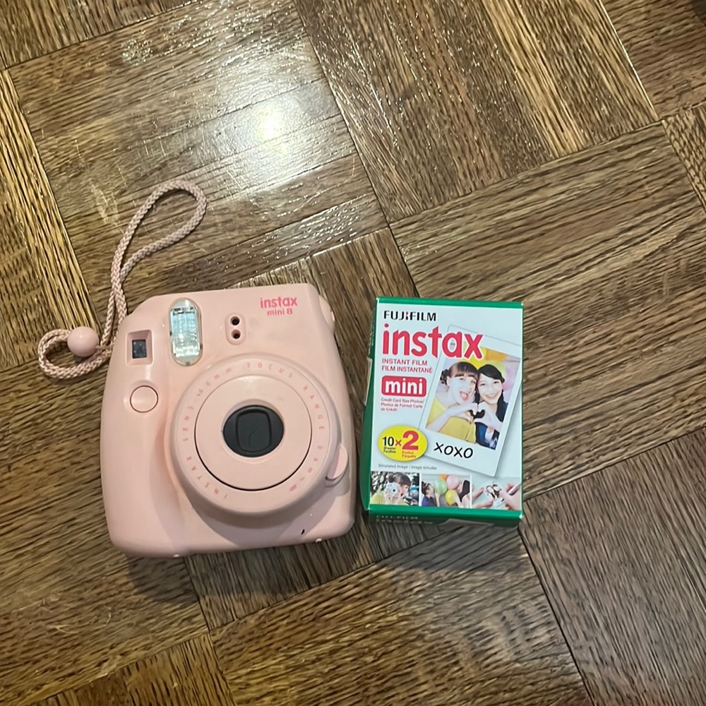 Pink Polaroid camera with film